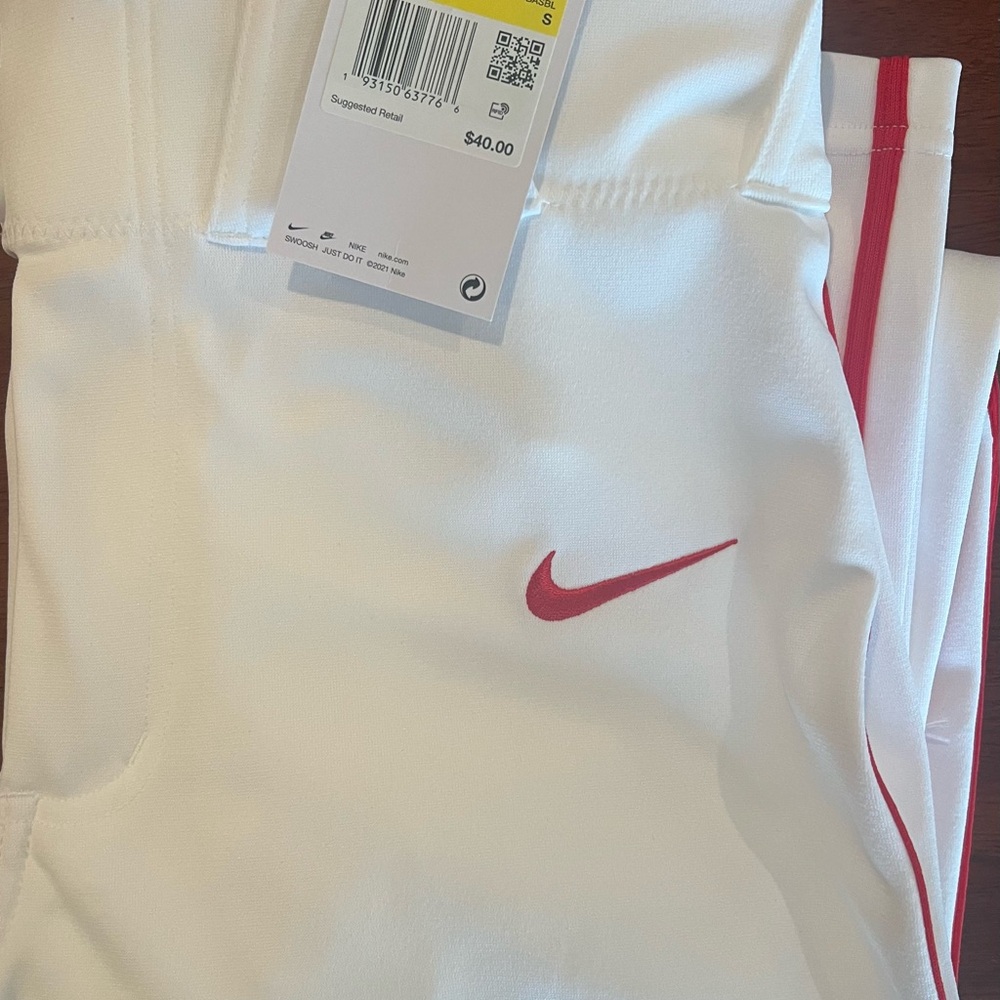 Nike white/red piping/red swoosh. These are straight leg, men’s small baseball.